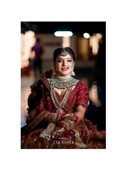 A beautiful, smiling portrait of the bride, her face illuminated, showcasing her stunning wedding jewelry and makeup.