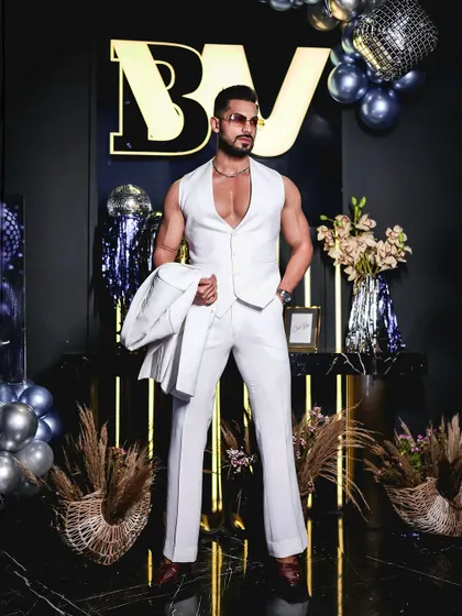 A full-length shot of the all-white suit, styled with the jacket off. This highlights the perfect tailoring of the waistcoat and trousers, each piece crafted to our exacting standards.