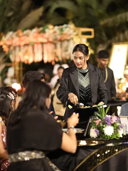 Our service staff attending to guests at their tables. We ensure that service is always attentive and proactive, anticipating the needs of every guest.