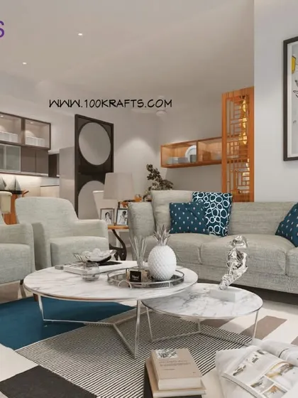 The living room from our 'Modern Ethnic' project at Janaki Rainbow Housing. The space is comfortable and inviting, with a neutral color palette and subtle ethnic touches in the decor.