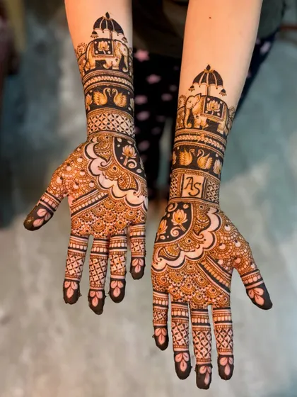 A slightly different angle of the "AS" initial mehendi, showing the beautiful symmetry and intricate patterns that cover the hands and arms.
