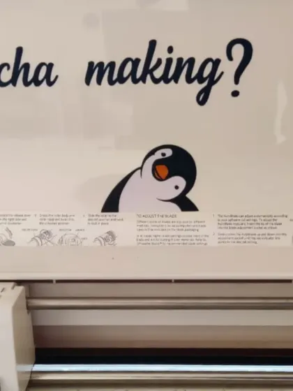 A peek at our vinyl cutter, "Sita Lakshmi," with a friendly penguin decal watching over it.