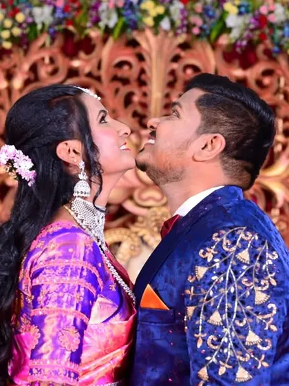A candid and joyful moment between the bride and groom, captured during their wedding reception.