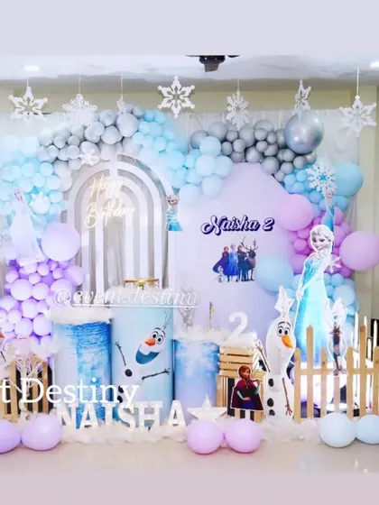 A complete view of our Frozen theme decor for a second birthday. We use character standees, themed pedestals, and a soft color palette to bring the world of Arendelle to your party.