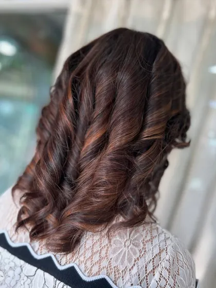 A gorgeous shade of brown with a soft, sun-kissed glow. The tight curls add texture and volume, bringing the hair to life.