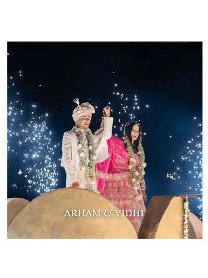 A joyous moment as the couple celebrates with fireworks. Their happy expressions and the sparkling background make for a perfect, high-energy wedding shot.