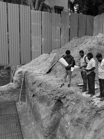 On-site, our team reviews blueprints against the excavated foundation. This is a critical step in our turnkey process, ensuring the architectural vision is accurately translated from paper to ground.