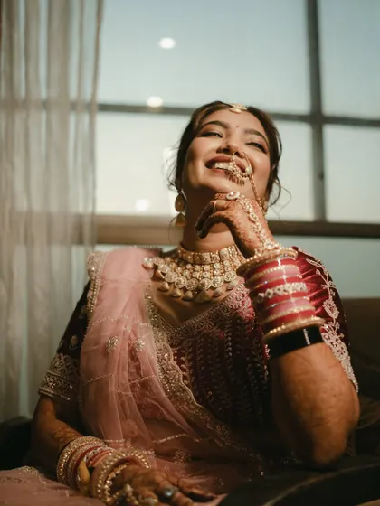 A moment of pure joy and laughter from the bride, a candid shot that radiates happiness.