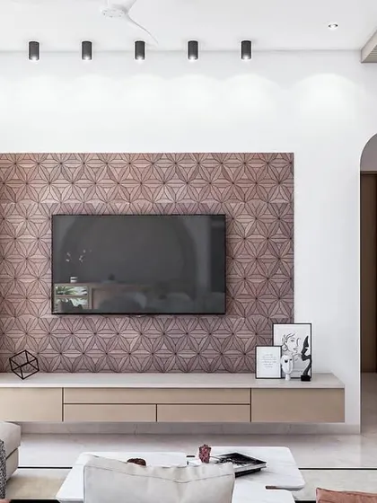 This minimalist TV unit features a stunning geometric-patterned veneer panel as its backdrop. The simple floating console and asymmetrical open shelving keep the focus on the intricate woodwork, creating a piece that is both a functional unit and a work of art.