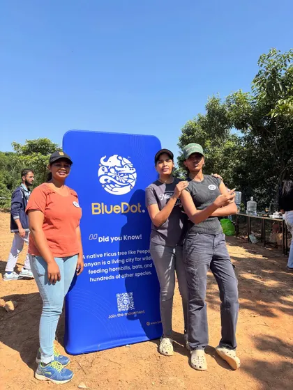 Participants pose with the BlueDot banner during the community tree-planting drive, one of our small steps alongside local planting work.