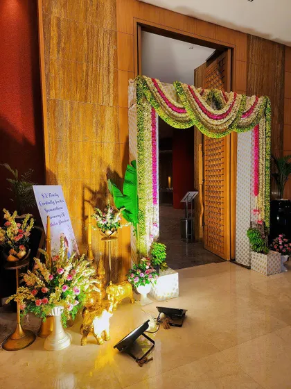 A beautiful entrance decoration for a baby shower, featuring a welcome sign and floral arrangements.