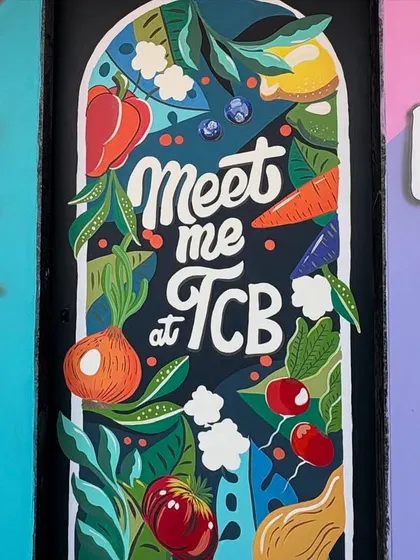 A straight-on view of the kitchen door mural, showcasing the playful lettering and vibrant illustrations of fresh ingredients.