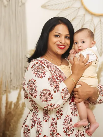 A lovely studio portrait of a mother and her baby. They both look towards the camera, capturing a sweet connection.