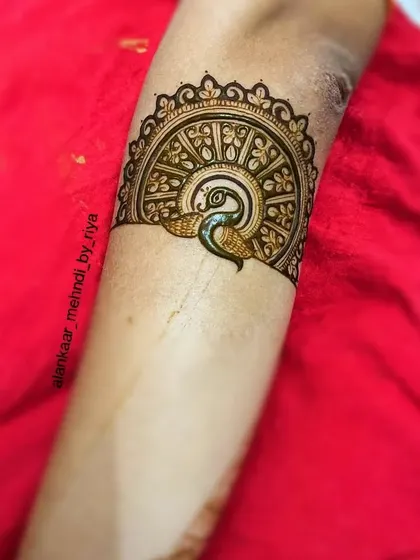 A beautiful bridal start-up design featuring a peacock within a semi-circular mandala, showcasing intricate feather details.