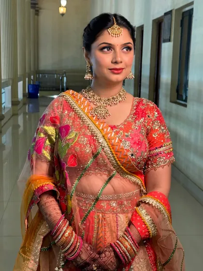 This shot highlights the beautiful blend of colours in her outfit and how the makeup enhances her festive look.