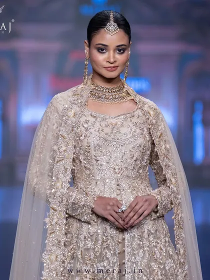 A vision in gold, this Tail Peplum Indo-Western is a masterpiece of subtle self-matching embellishments and exotic ornamental designs.