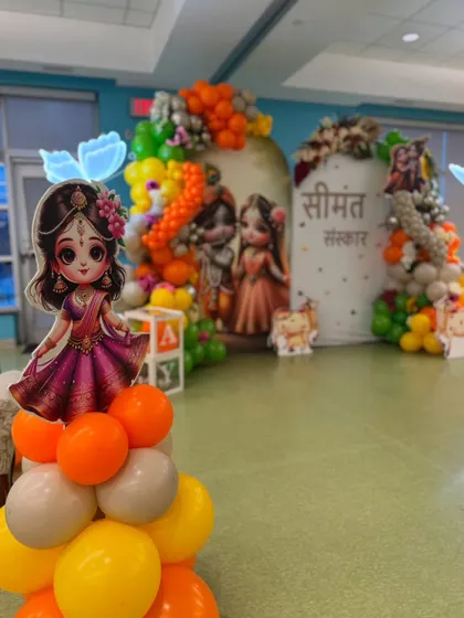 Another angle of the Seemantha Sanskar setup, highlighting a cutout of Radha. These character elements are placed throughout the venue to create an immersive and thematic experience for guests.