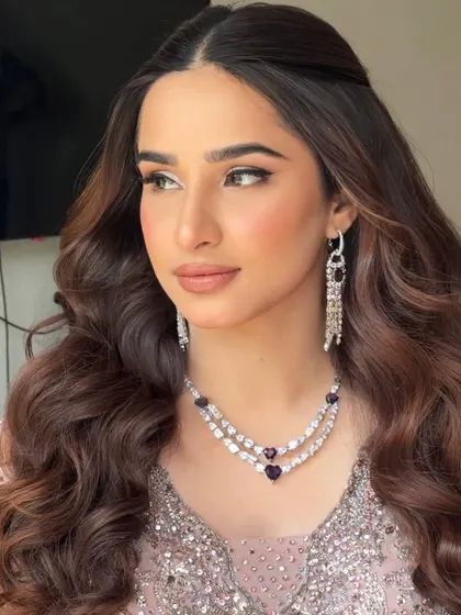 A side profile showcasing the soft, rosy, and radiant glam for her Sangeet. The silver shimmer on the eyelids adds a touch of modern sparkle.
