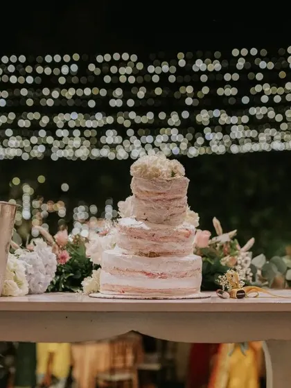 The wedding cake deserves its own beautiful moment. We set up this simple yet elegant table for the cake and champagne, with a backdrop of twinkling lights to make the moment even more special.