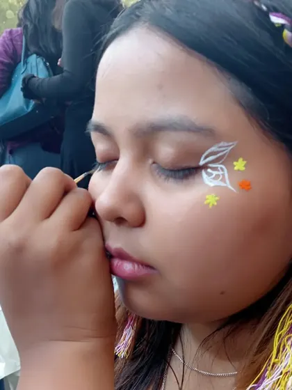 Painting a whimsical design with white outlines and small colorful flowers. It's a joy to bring these ideas to life.