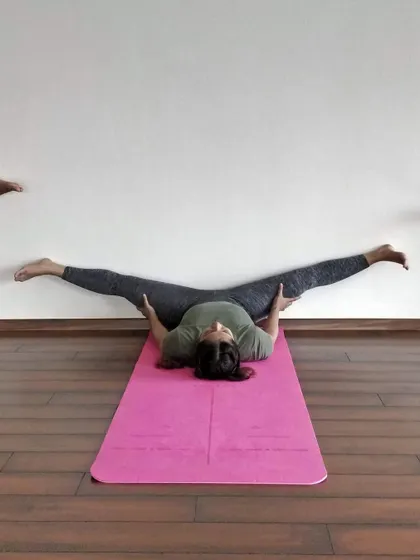 A wall-supported split, or Samakonasana, is a fantastic way to safely work on deep hip flexibility.