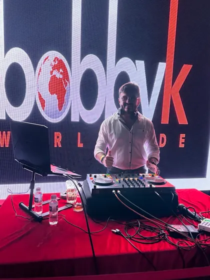 My office is the stage. Here I am at my console with my 'Bobby K Worldwide' logo in the background, ready to take my music anywhere.