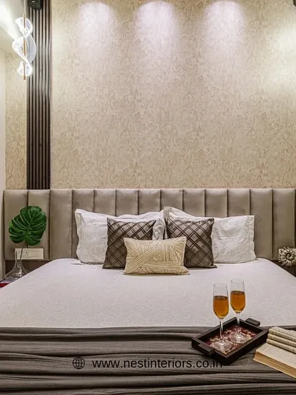 The headboard wall is accentuated with textured wallpaper and stylish pendant lights. This creates a focal point and adds a layer of sophistication to the room's design.