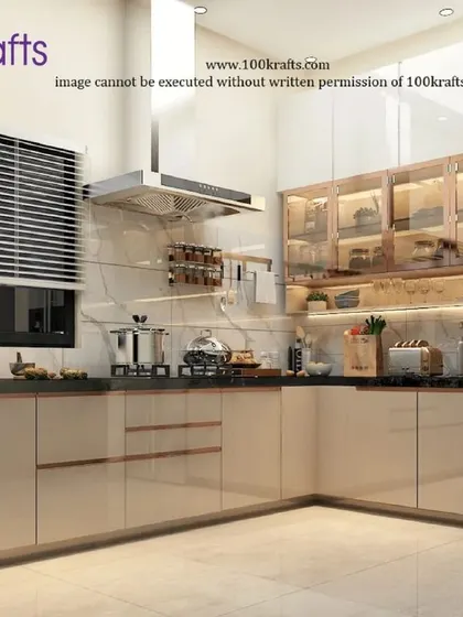The kitchen from our 'Modern Traditional Glam' project in Pune. It features sleek, high-gloss cabinets, a marble backsplash, and well-lit glass-front upper cabinets for a clean and glamorous look.