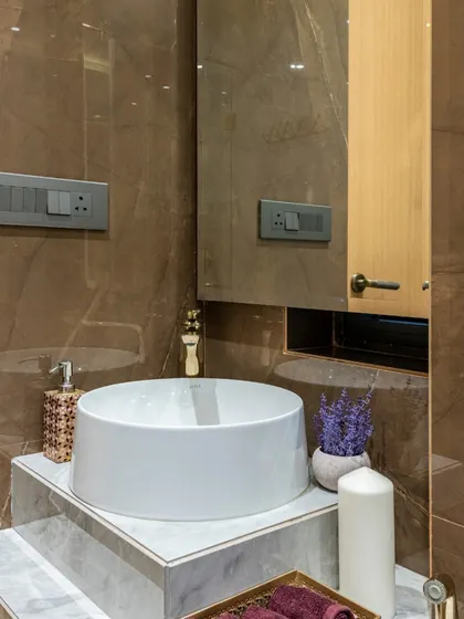 A detail of the powder room in the Filigree House, showing the stepped marble vanity. The design is simple yet elegant, showcasing the beauty of the natural stone.