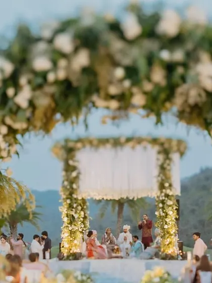 A view through the floral entrance arch to the 'Luxe Garden' mandap. This framing shot shows how we create layers of beauty, guiding the eye and building a sense of journey.