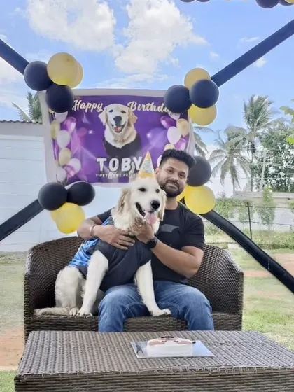 Toby and his dad posing for a picture before the cake-cutting. We make sure to have a custom banner ready for every birthday pet.