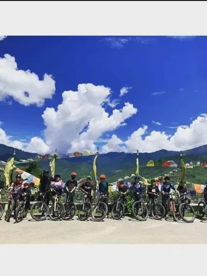 A group of cyclists enjoying the incredible views on a clear day in Bhutan. The combination of culture and scenery is unmatched.