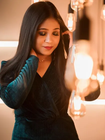 A softer, more candid shot of the smokey cocktail makeup. This shows how the look appears in warm, ambient lighting, highlighting the shimmer on the eyelids and the smooth skin finish.