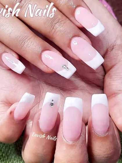 A subtle take on the French manicure, with soft pink nails and white tips, accented by a few small crystals for a hint of shimmer.