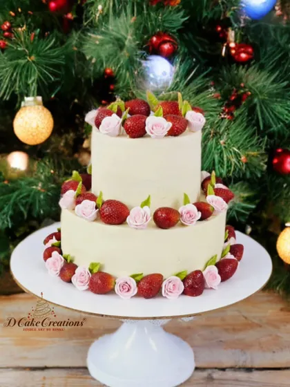 A simple and elegant two-tier cake perfect for the strawberry season. This cake is frosted with smooth buttercream and decorated with fresh strawberries and delicate pink sugar roses.