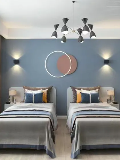 This modern twin bedroom features a calming blue accent wall and symmetrical design. With two separate beds, individual wall sconces, and a shared wardrobe, it's a balanced and stylish space for siblings.