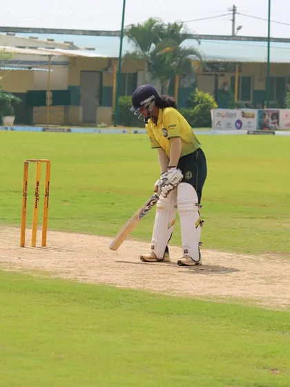 A lone batter stands at the crease, focused and prepared, on our full-length turf pitch.