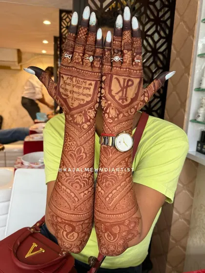 This full backhand design combines a custom wedding logo with personal messages and traditional Indian motifs for a truly unique bridal look.