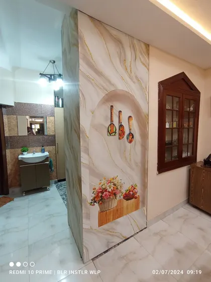 A custom 3D-effect mural on a partition wall, creating the illusion of a niche with decorative items.