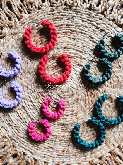 A colorful collection of macrame spiral knot hoop earrings. These are customizable in various sizes and colors, making them a great option for party favors or bridesmaid gifts.