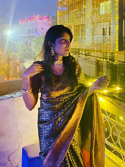 Another shot of my Diwali look, this time on a rooftop surrounded by festive lights. The rich fabric of the saree catches the light beautifully, perfect for an evening celebration.
