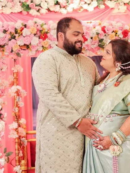 A lovely couple portrait from a baby shower. The mom-to-be is wearing a custom set I designed with white and purple flowers to match her beautiful pastel saree.