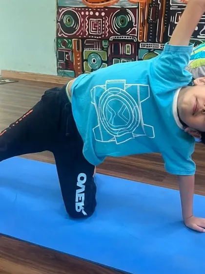 This young student demonstrates great form and focus during a yoga pose at our summer camp. I believe in making fitness fun and accessible for all ages.