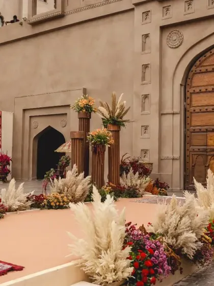 The entrance to the wedding ceremony, where a custom mural painted by the bride herself welcomes guests. This personal touch, merging maps of India and Lebanon, beautifully represents the couple's story.