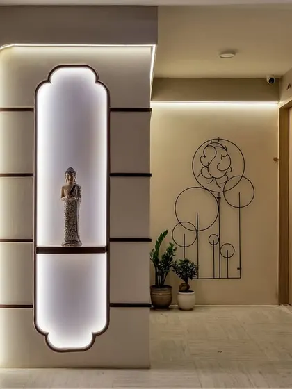 Ready to make a grand entrance? This hallway uses backlit niches, sculptural art, and warm, indirect lighting to guide the way, turning a simple passage into a curated gallery experience.