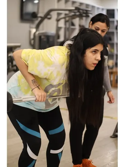 Learning the bent-over barbell row can be tricky. A trainer provides form correction to protect the lower back and maximize engagement of the upper back muscles.