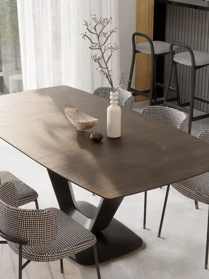 The dining area in the penthouse, where a sleek, modern table is surrounded by houndstooth-patterned chairs, overlooking the city through floor-to-ceiling windows.