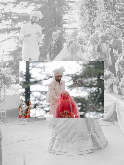 An artistic, layered shot of the Varmala ceremony. The black and white background emphasizes the colorful, emotional moment in the foreground.