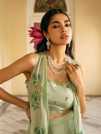 A confident and stylish portrait showcasing a modern ethnic look. The pop of pink from the flower adds a fresh, vibrant touch.