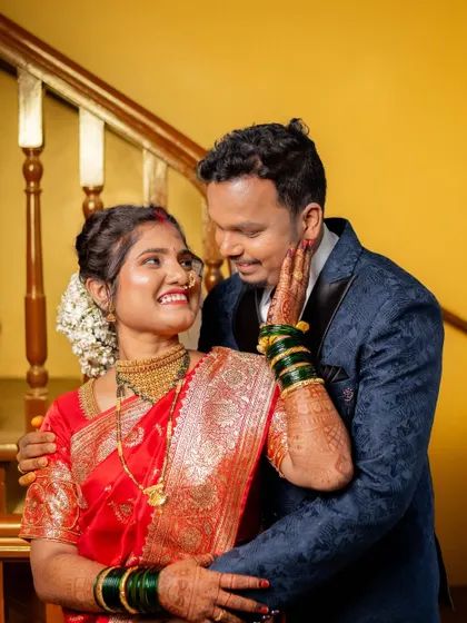 A sweet, candid moment between the bride and groom, sharing a laugh and a loving look after their wedding.